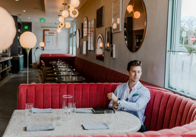 a man sitto=ing in the restaurant